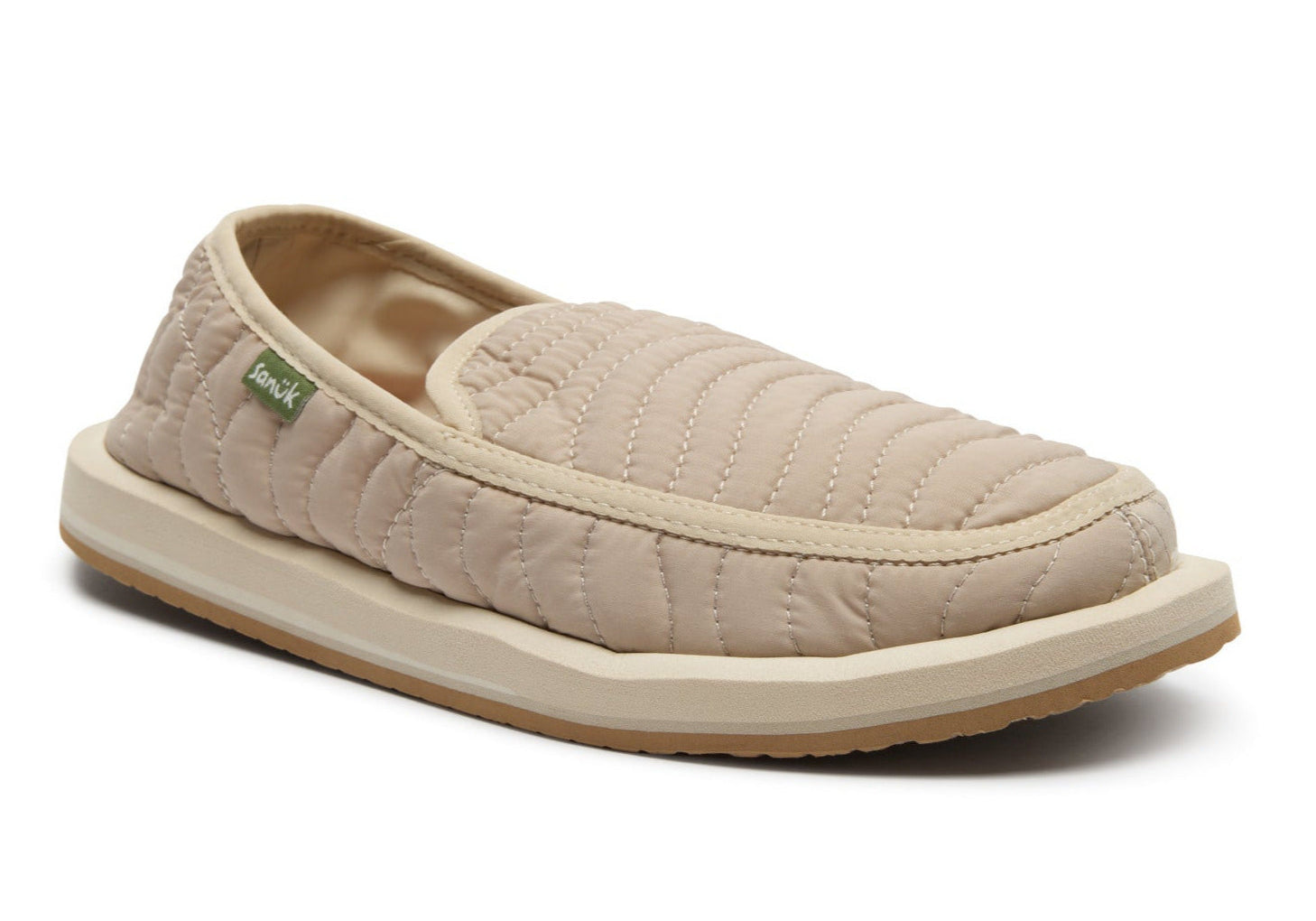Beige quilted slip-on shoe on a white background