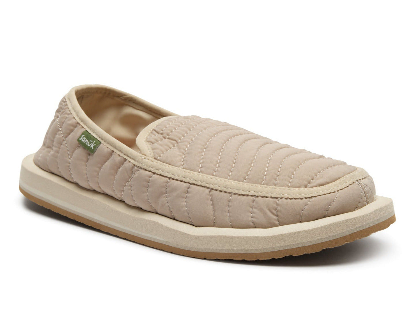 Beige quilted slip-on shoe on a white background